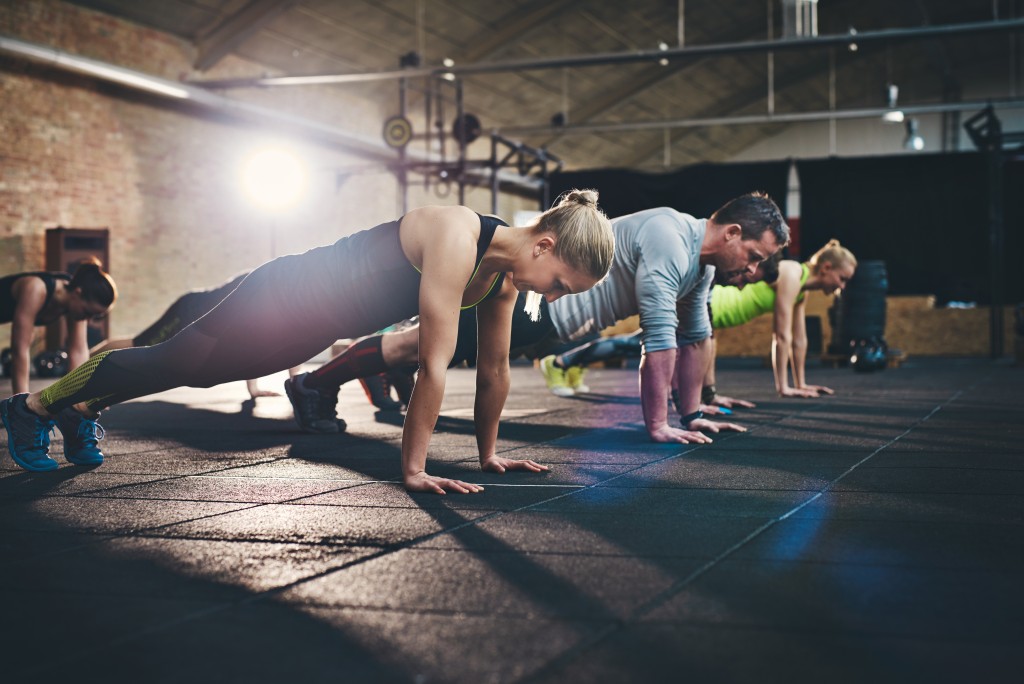 men and women training for rock climbing in gym